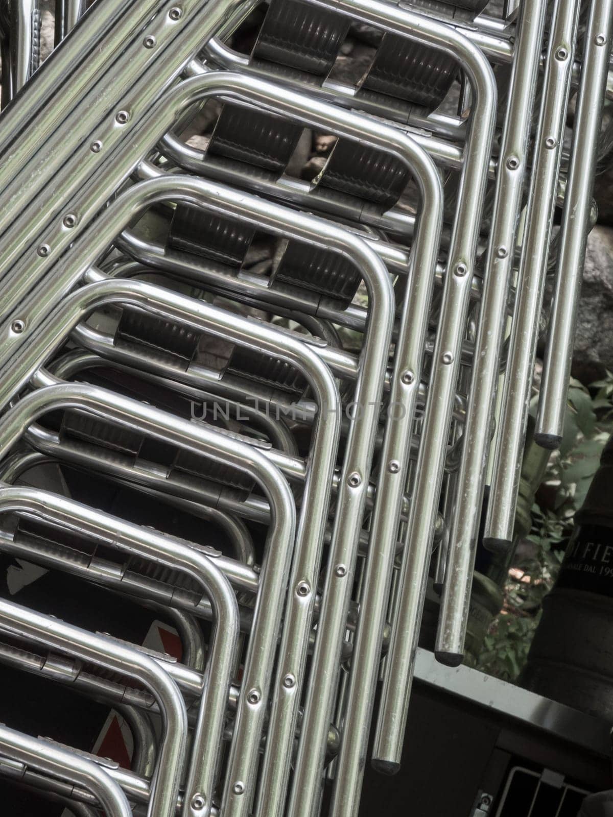 Detailed view of stacked chairs with metal frame.