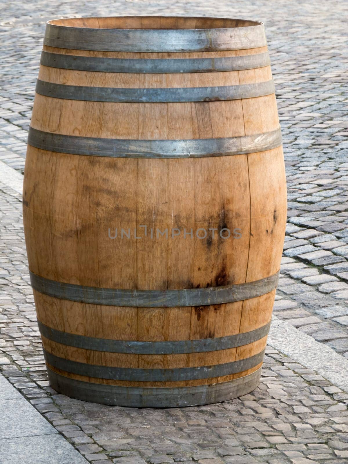 Single wooden barrel on the sidewalk in Lutherstadt Wittenberg.
