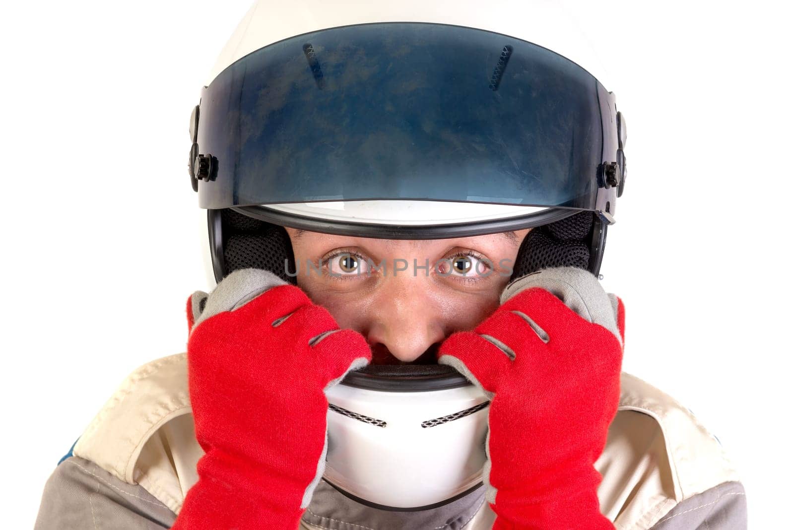 Racing driver posing with helmet isolated in white