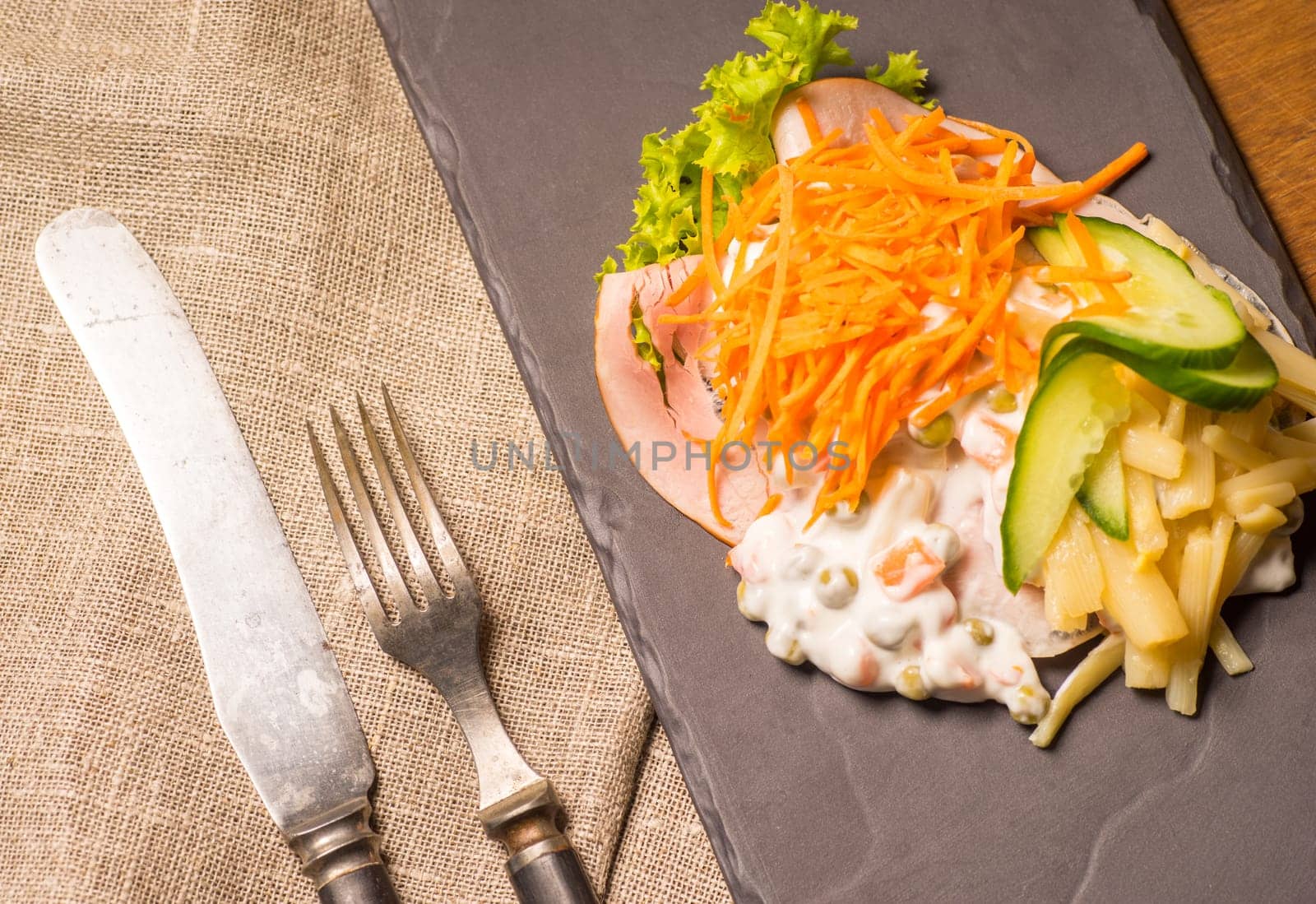 Danish specialties and national dishes, high-quality open sandwich. Sandwich with sliced ham, Mayonnaise with green peas and carrot tart, cracked carrots, asparagus and cucumbers