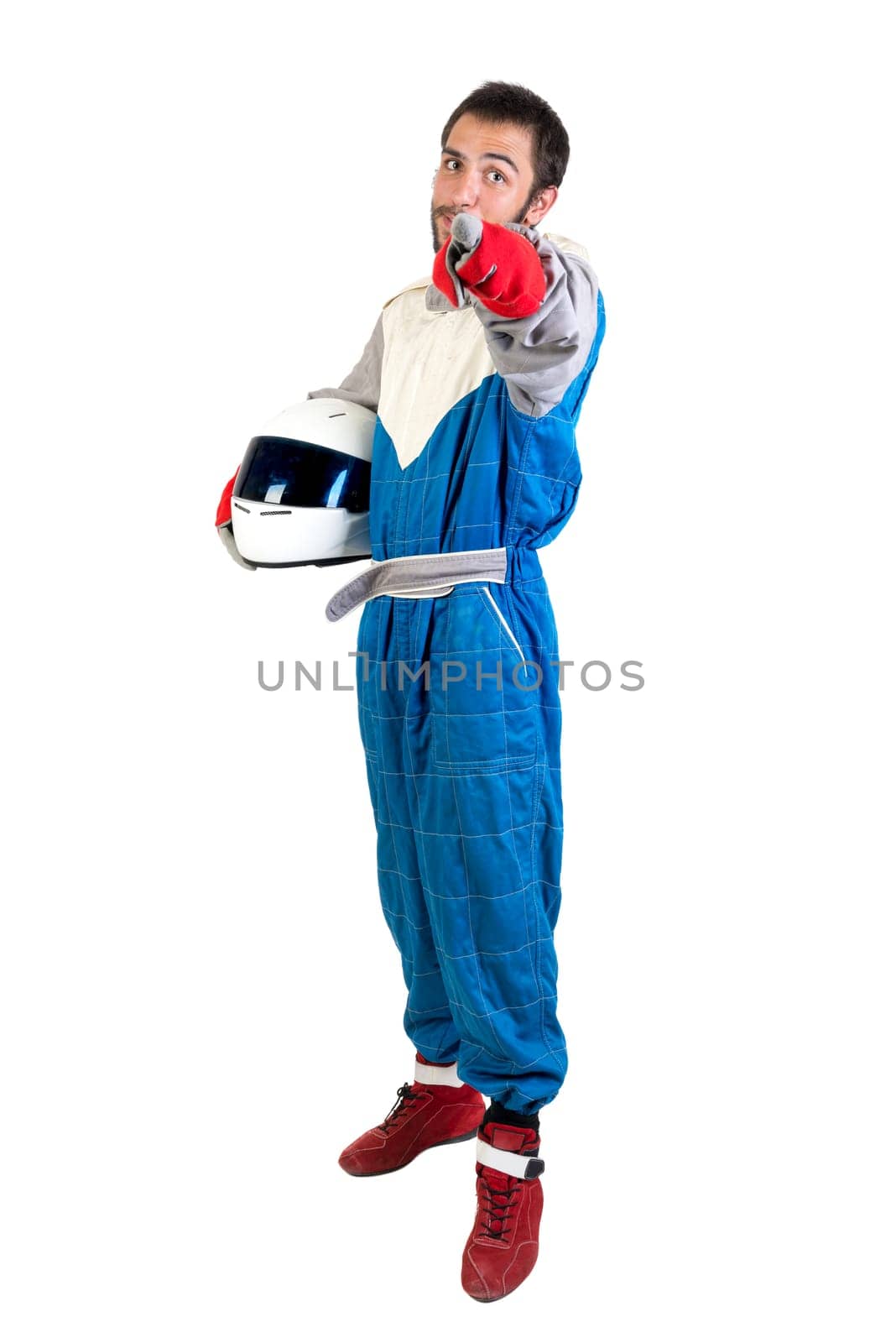 Racing driver posing with helmet isolated in white