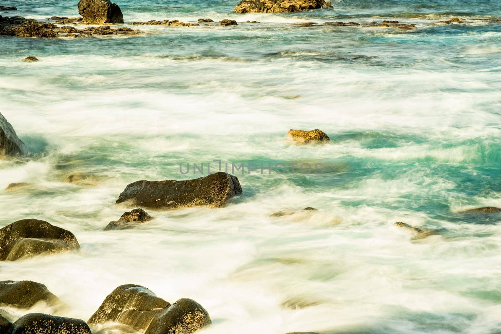 Surf of the Atlantic Ocean with rocks in long exposure