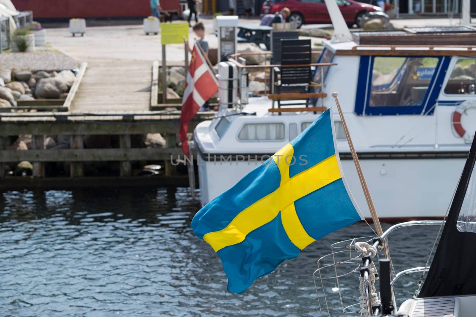 small swedish flag on a yacht in the Hundested harbor in Denmark