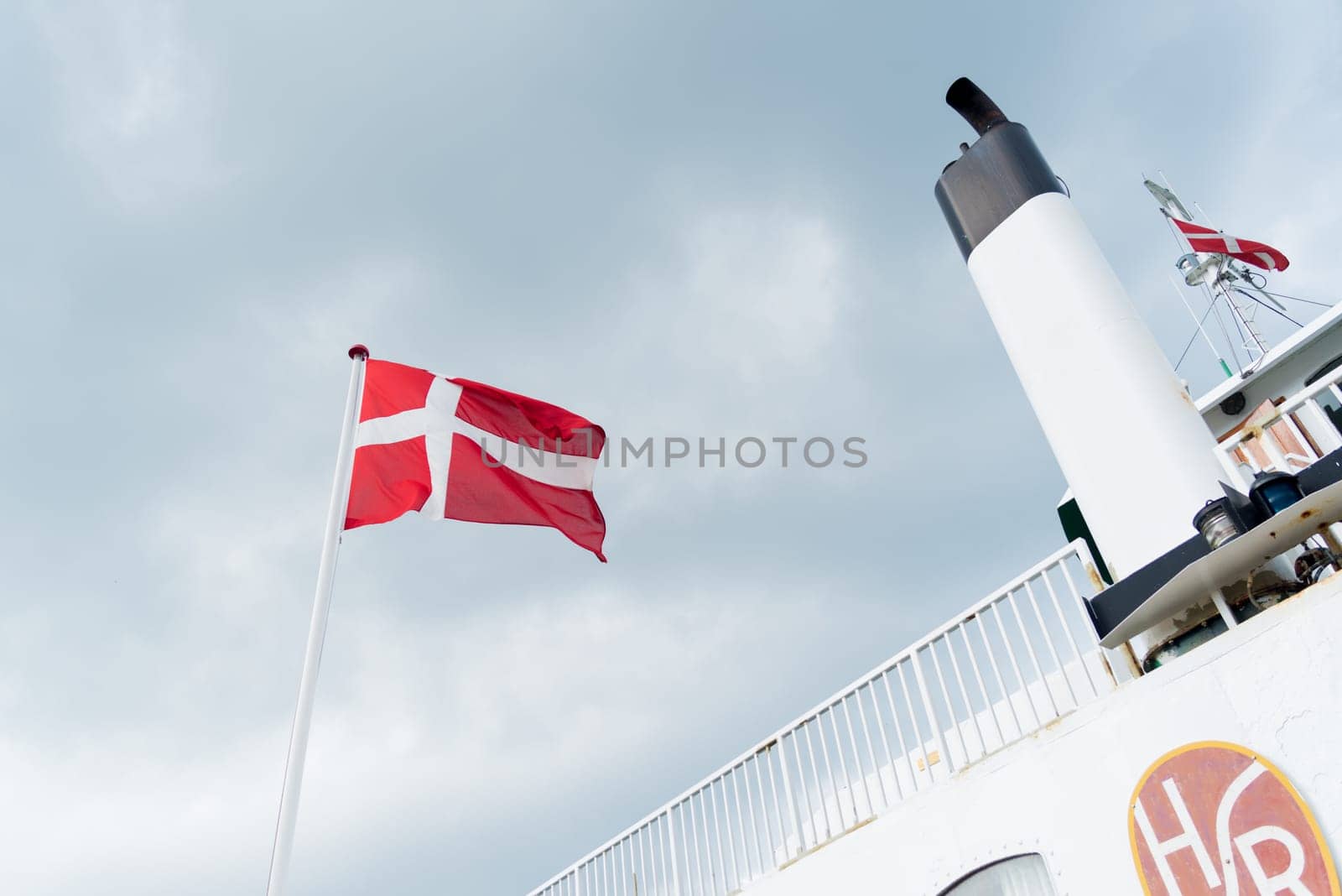 HUNDESTED, DENMARK - AUGUST 8, 2016: Danish flag on the Hundested - roervig ferryboat