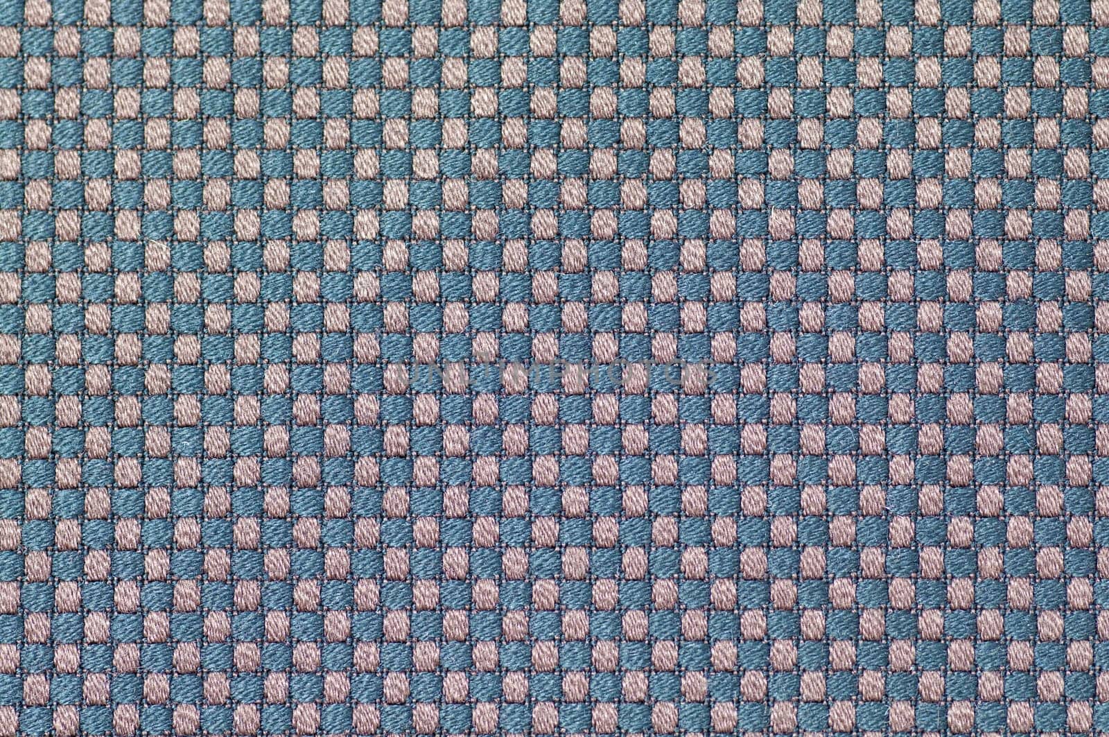 Close up checked woven woolen rug fabric pattern background.