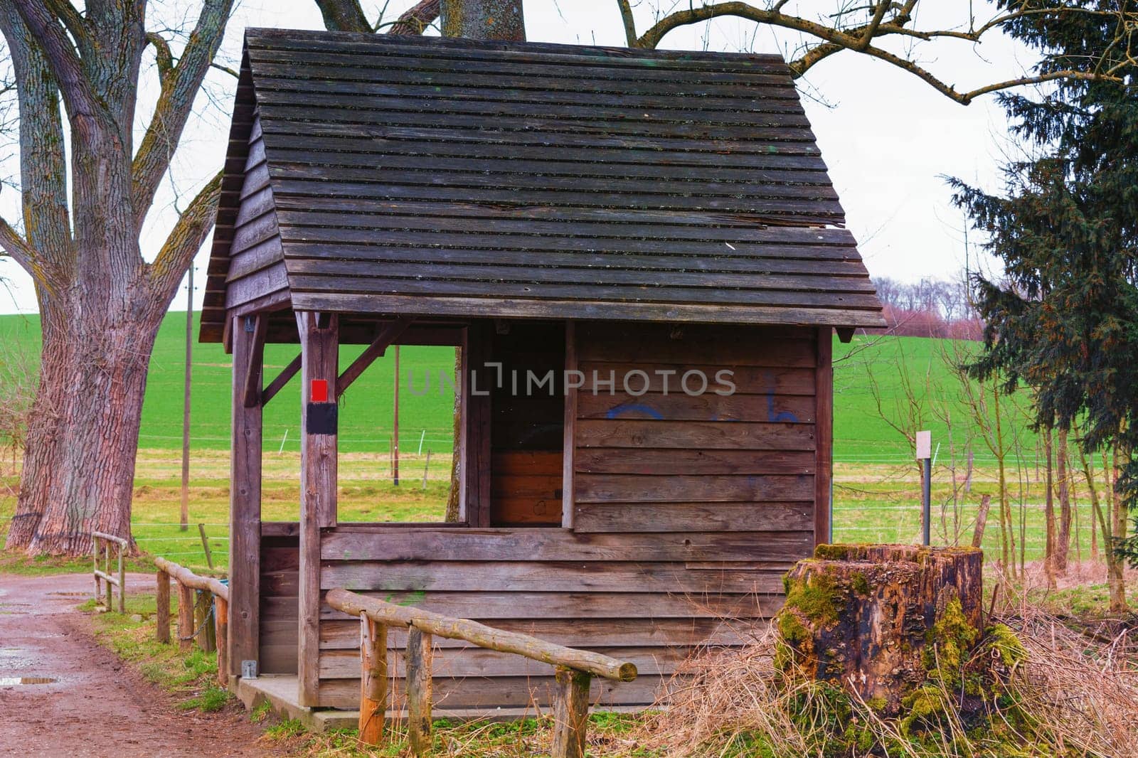 Old wooden hut to protect against wind,rain or snow at a pond near the town of Heiligenhaus in Germany.