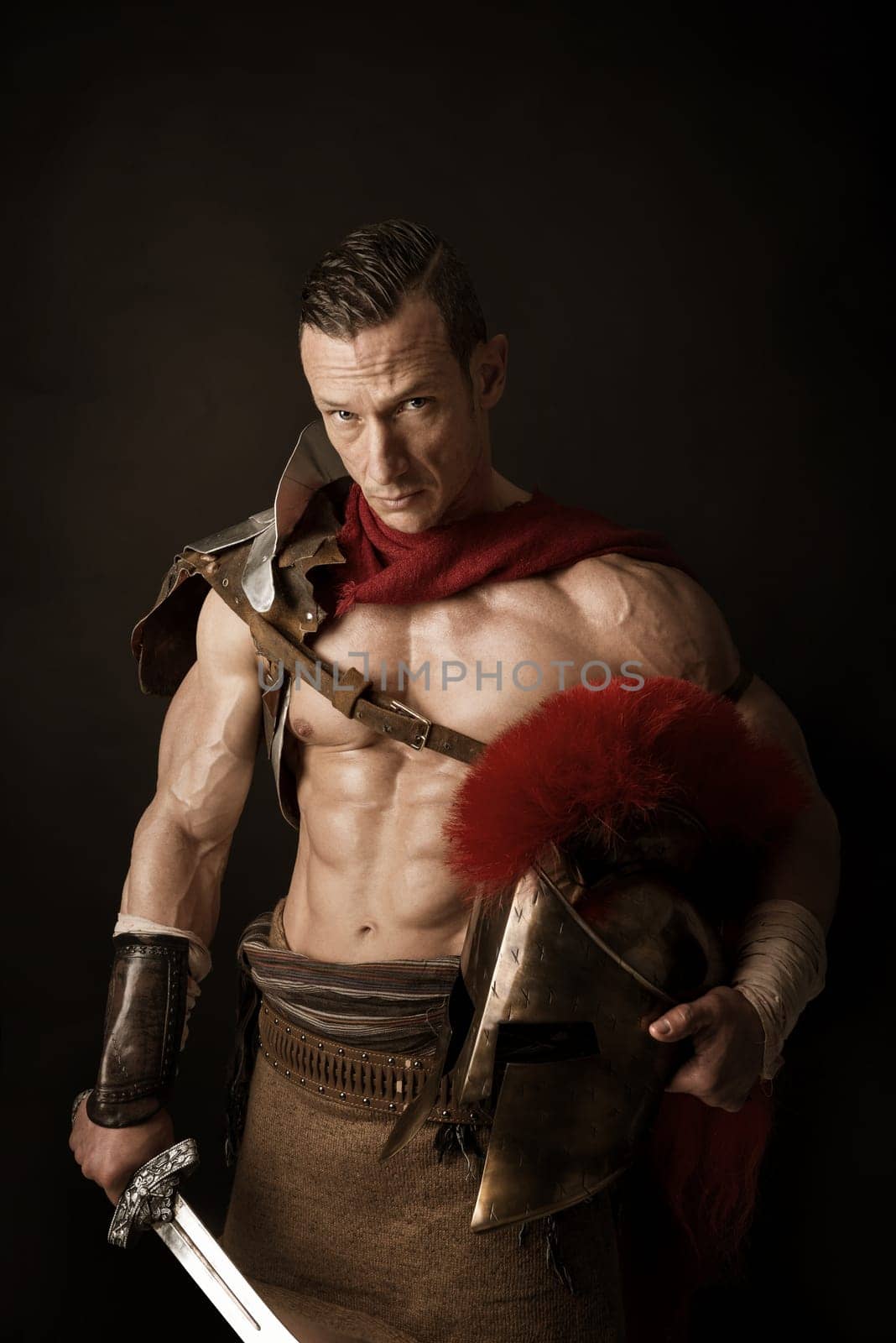 Ancient warrior or Gladiator posing over a dark background