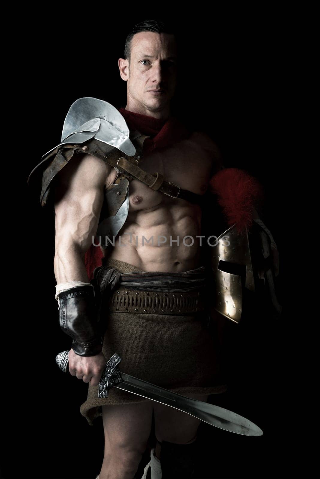 Ancient warrior or Gladiator posing over a dark background