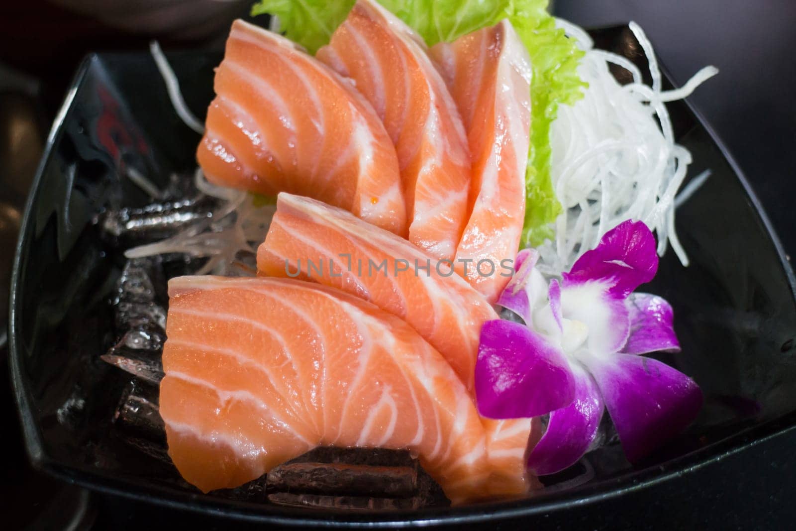 Sliced Salmon Sashimi Served On Black Plate, stock photo