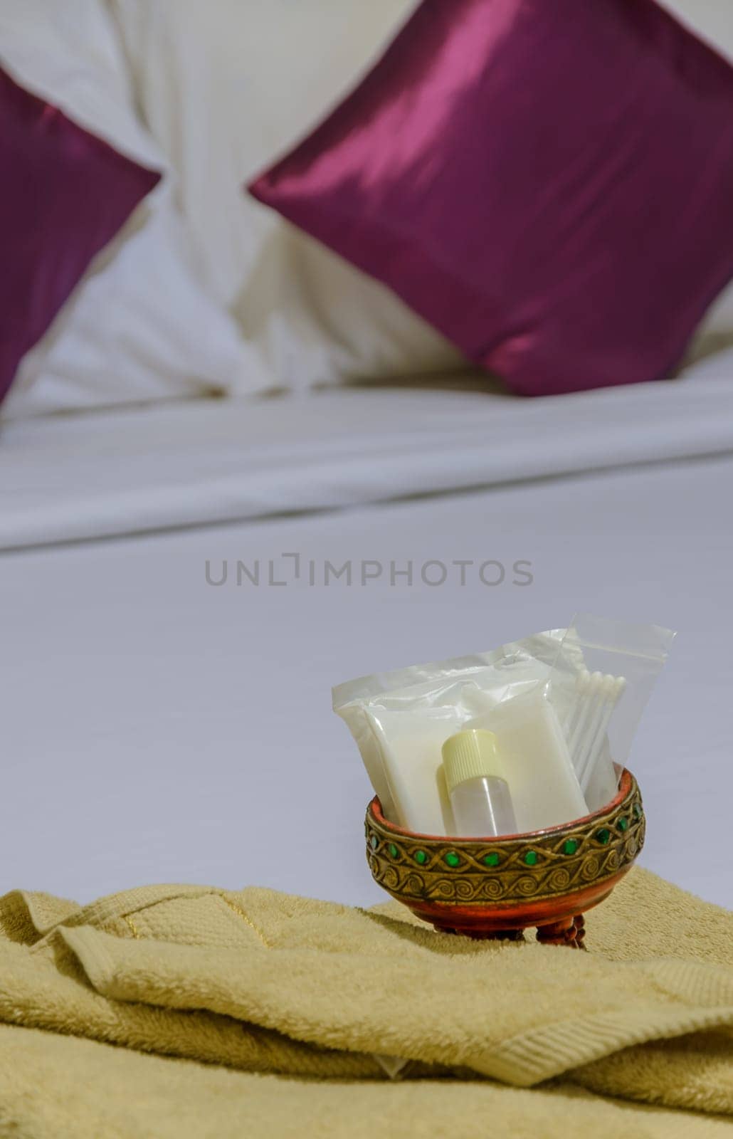 Shower set and yellow towel on bed sheet linen