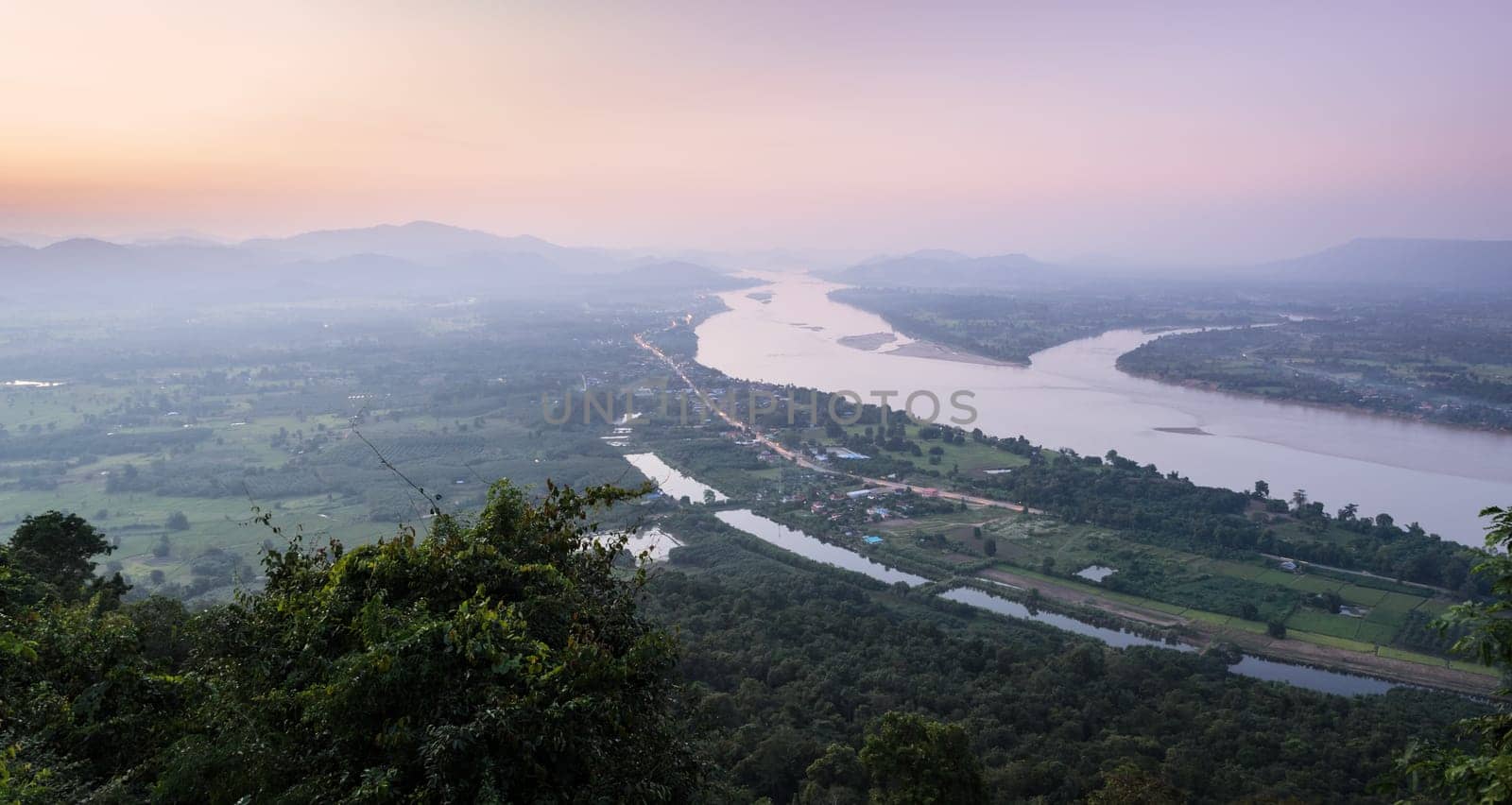 Aerial landscape view of Mekong river with mountain ranges at twilight in Nong Khai Province, Thailand