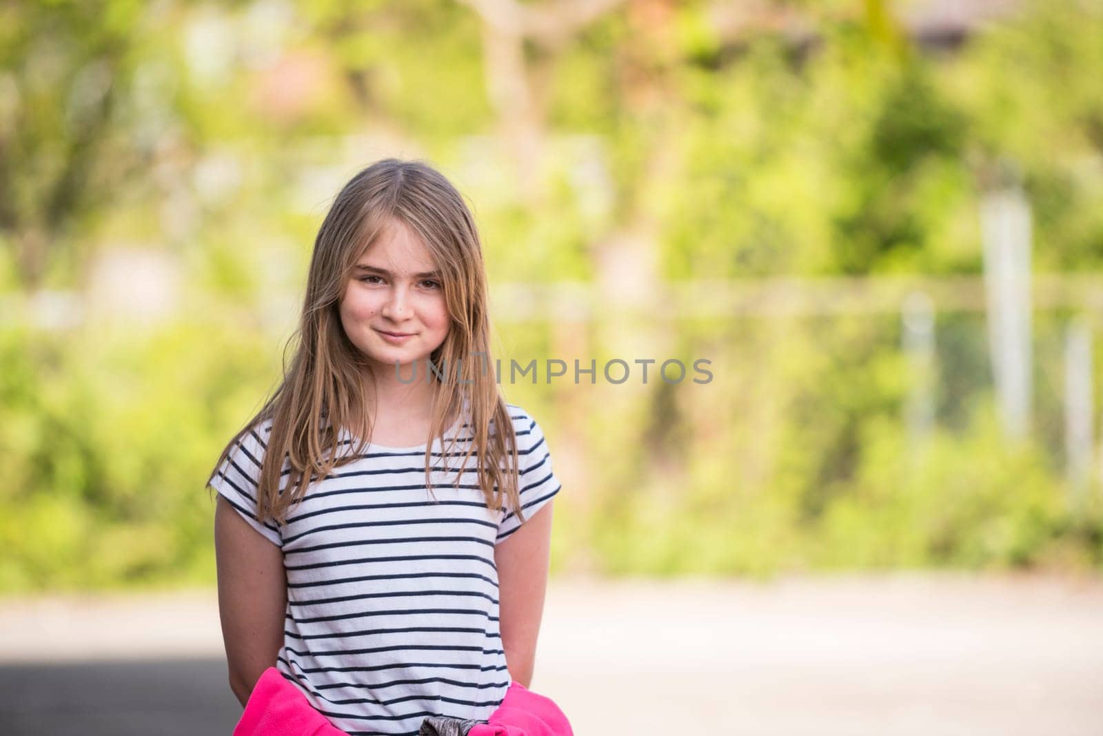 Cute blonde girl posing outdoor on a beautiful spring day