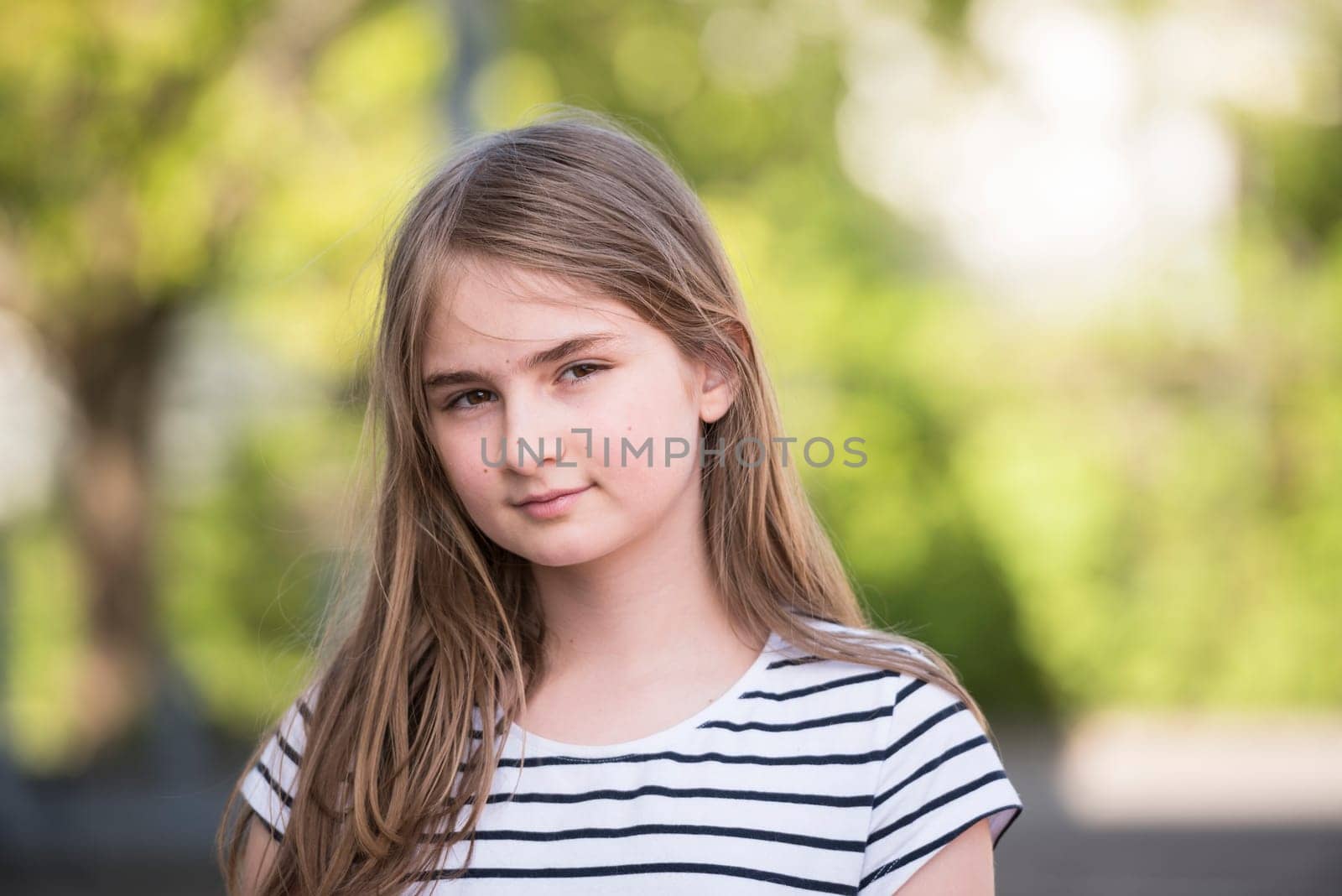 Cute blonde girl posing outdoor on a beautiful spring day