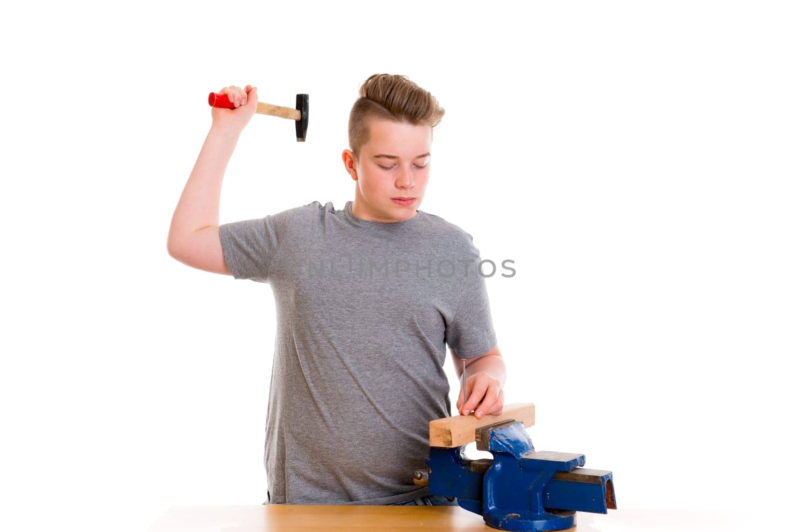 teenager in professional training wth hammer in front of white background