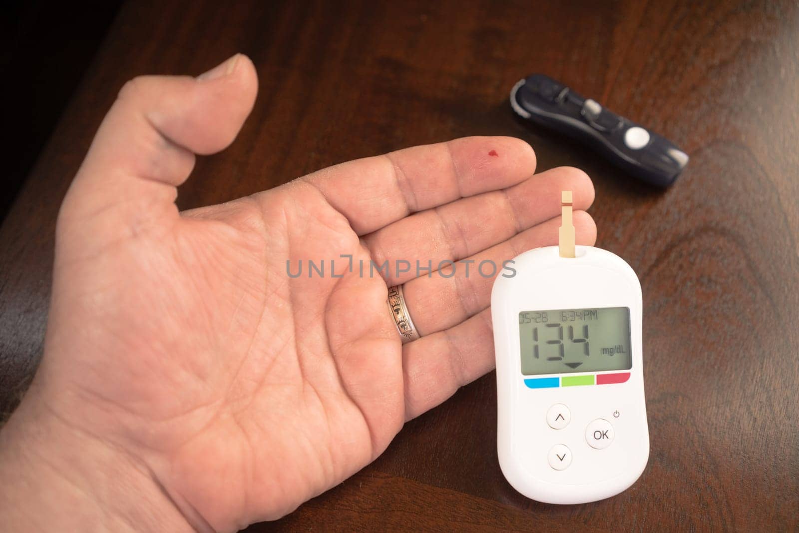 Digital tester indicates a blood glucose level of 134