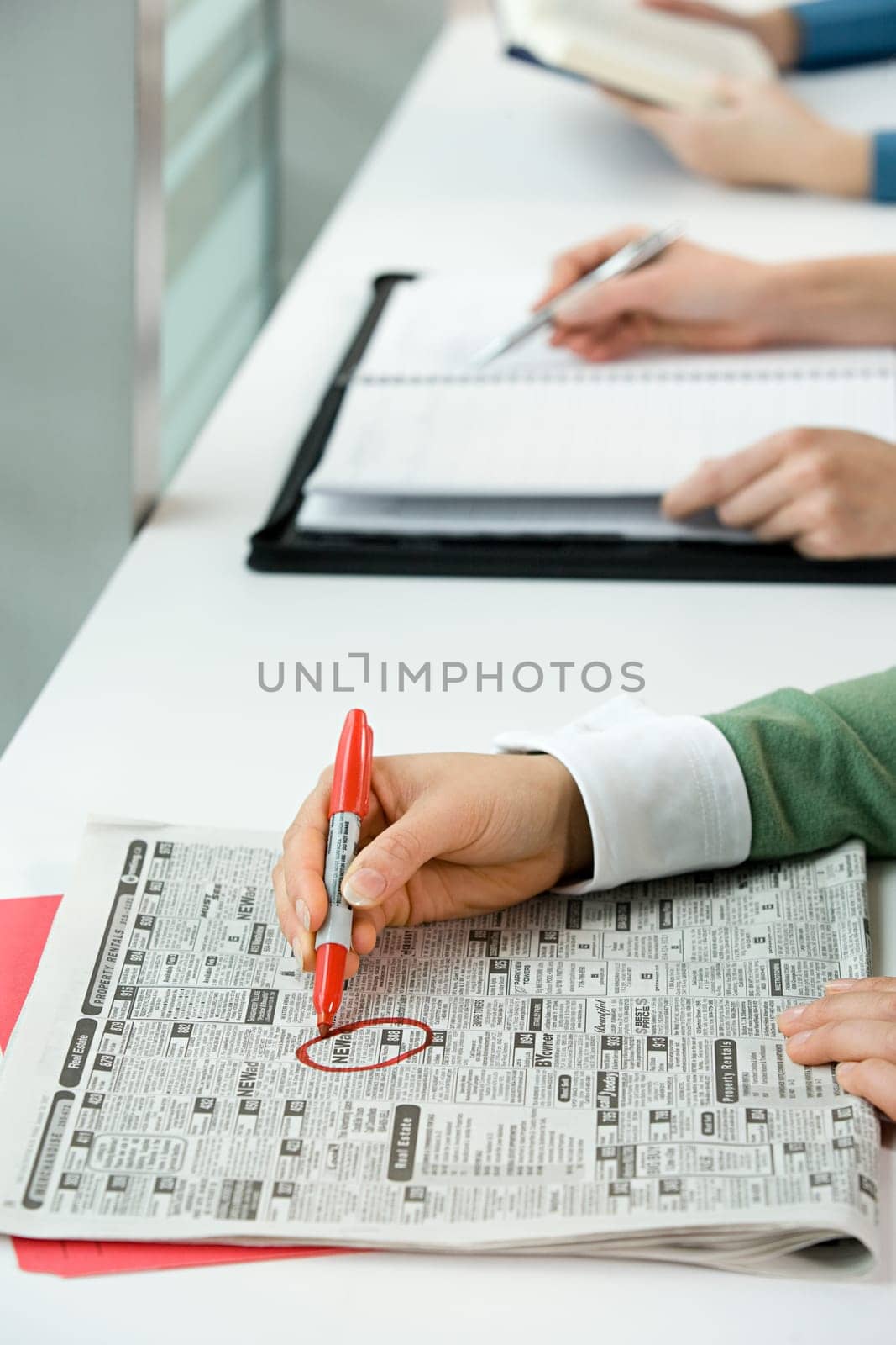 People with newspaper and books