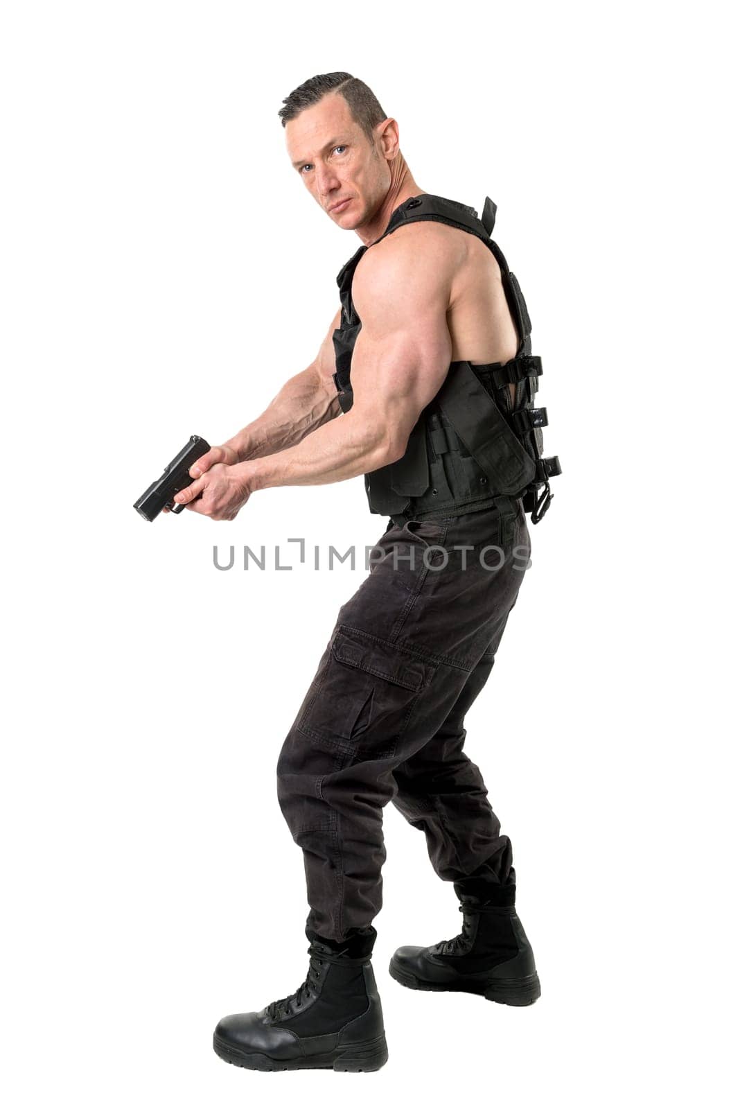 Man with tactical vest and gun isolated in white