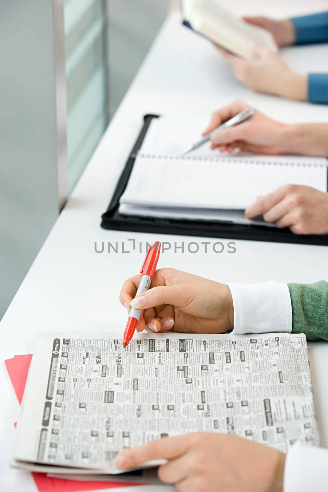 People with newspaper and books