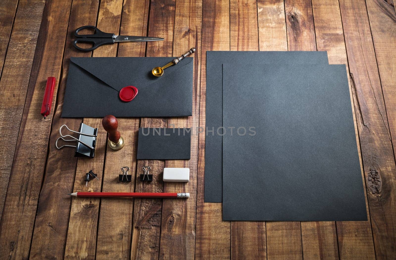 Black stationery mock up. Blank paperwork template for designers. Responsive design mockup on vintage wooden table background.
