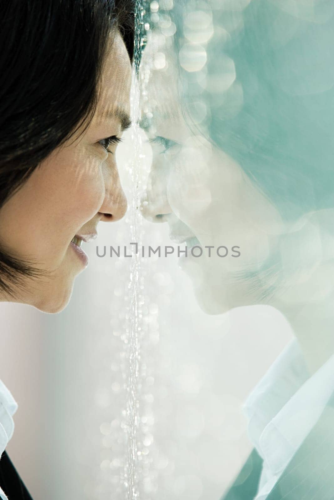 Chinese businesswoman with face to window