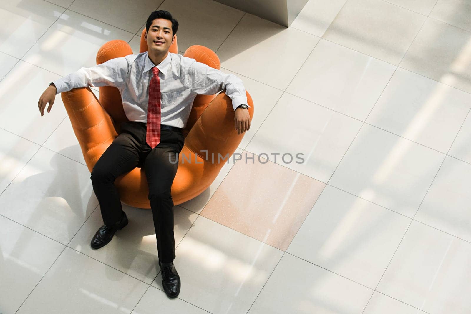 Chinese businessman relaxing in an armchair