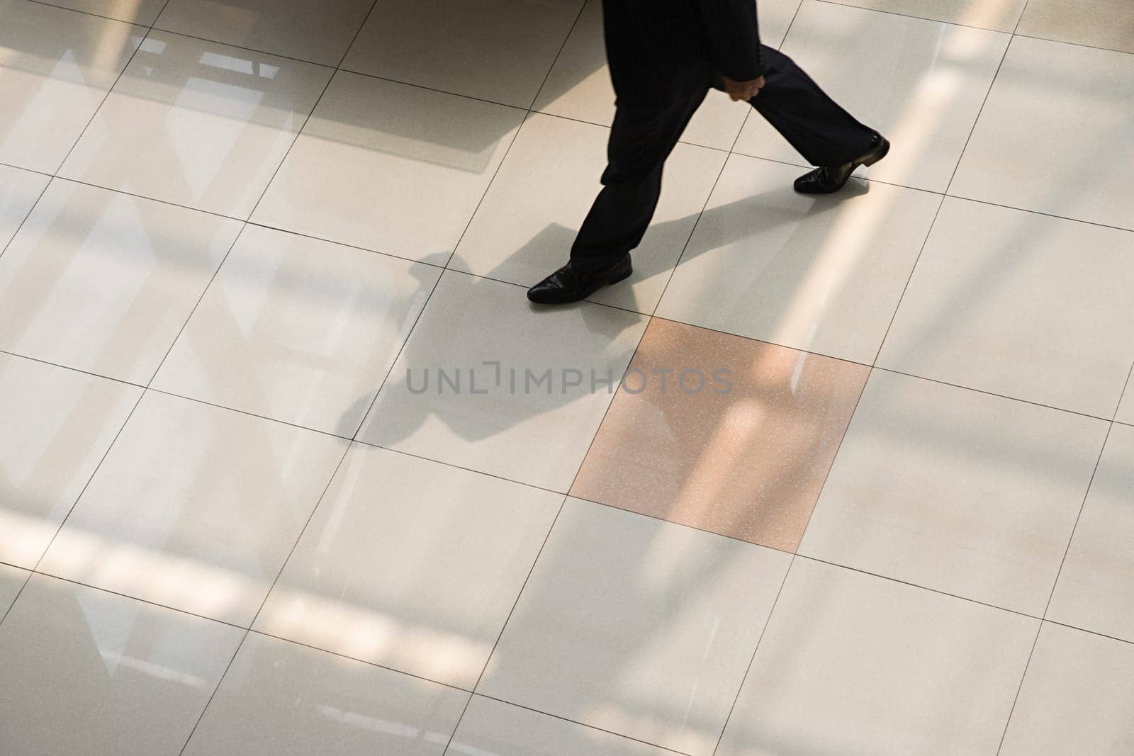 Businessman walking on tiled floor