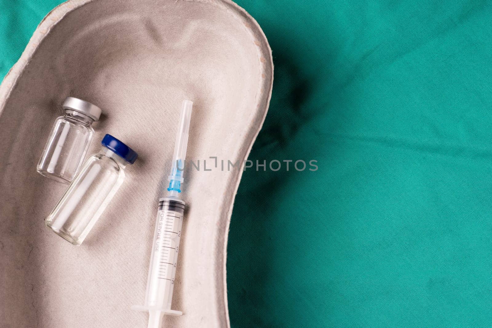 Medical Stethoscope lying on the hospital's green background. The background can be a textile part of a doctor or nurse's work uniform