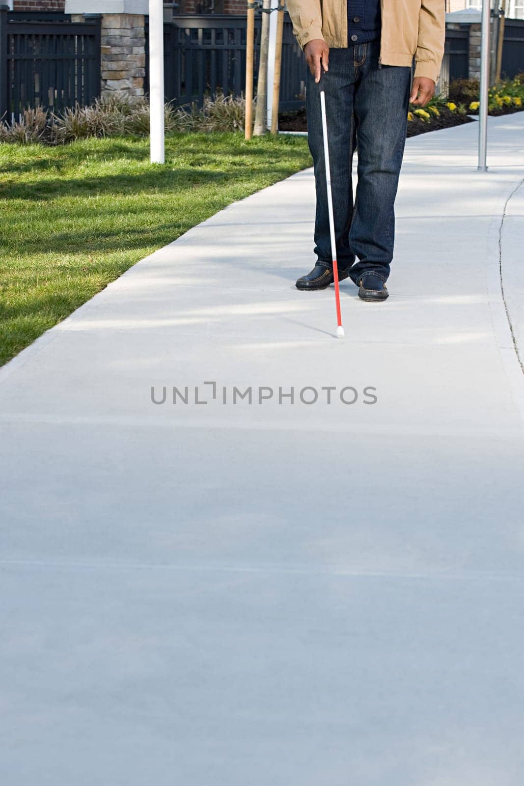 Blind man walking with a stick