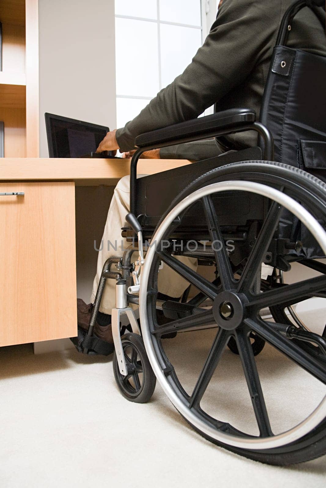 Rear view of a disabled man in a wheelchair