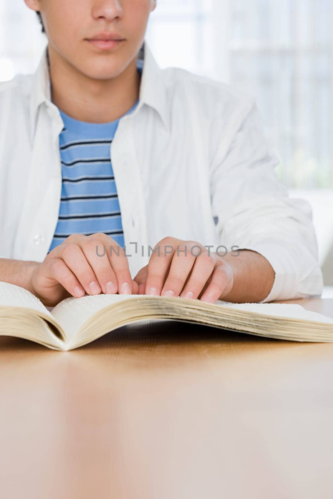 Blind boy reading a braille book