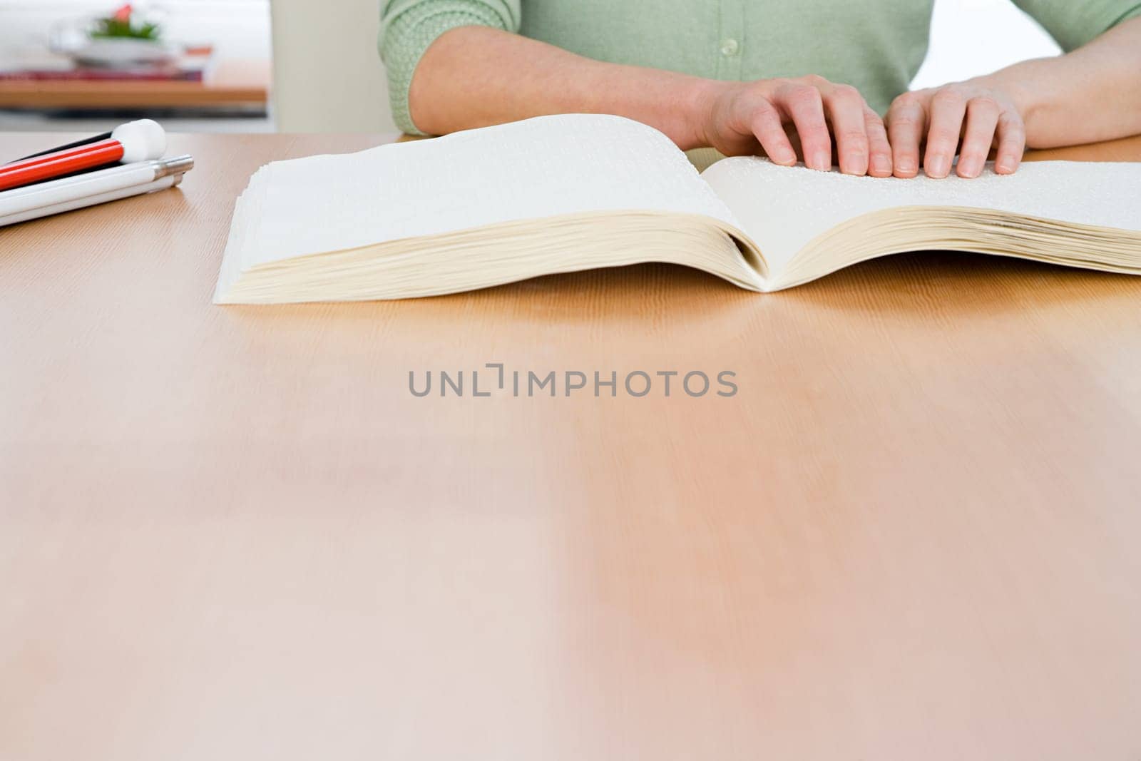 Woman reading a braille book