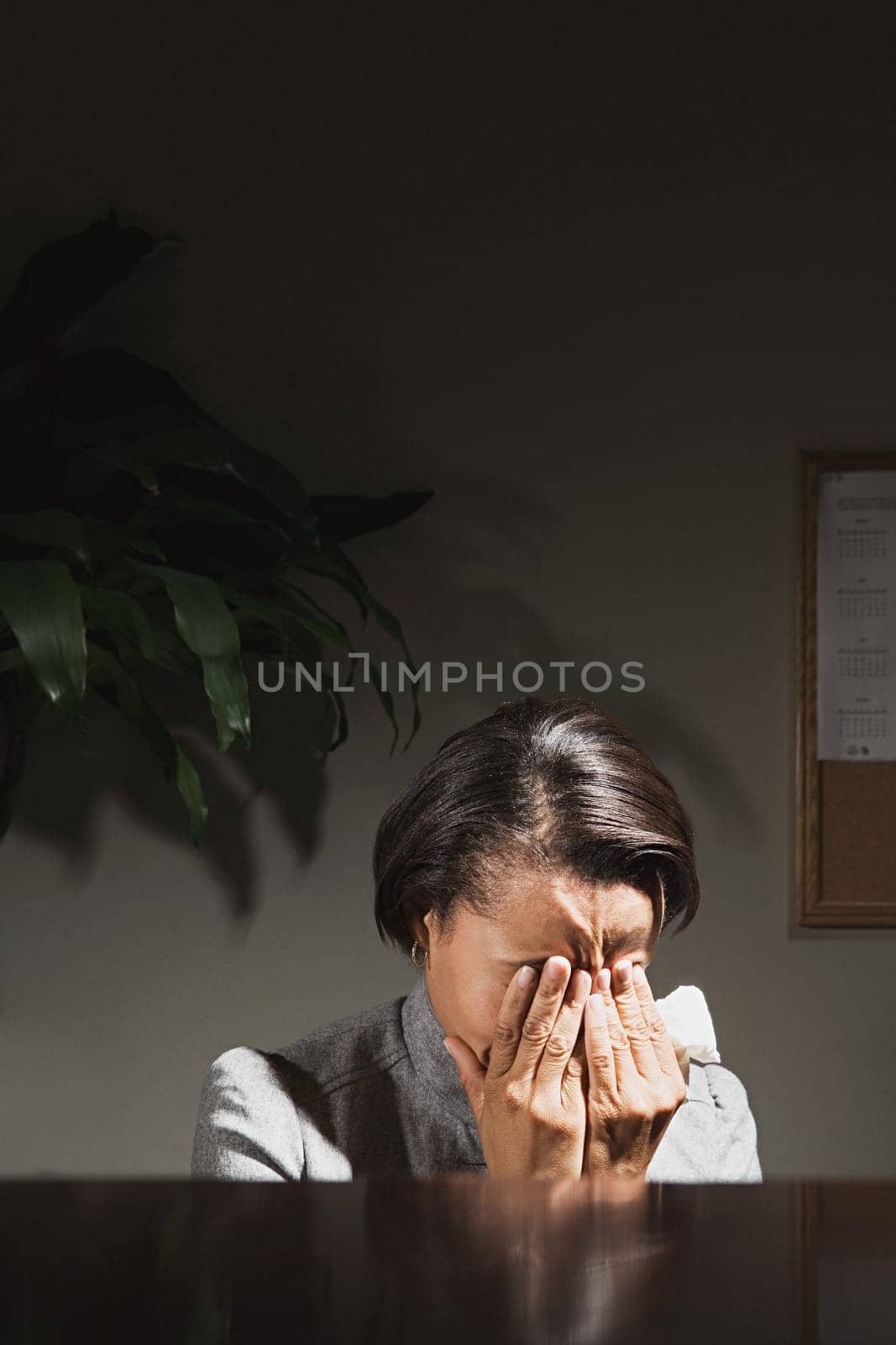 Businesswoman with her head in her hands