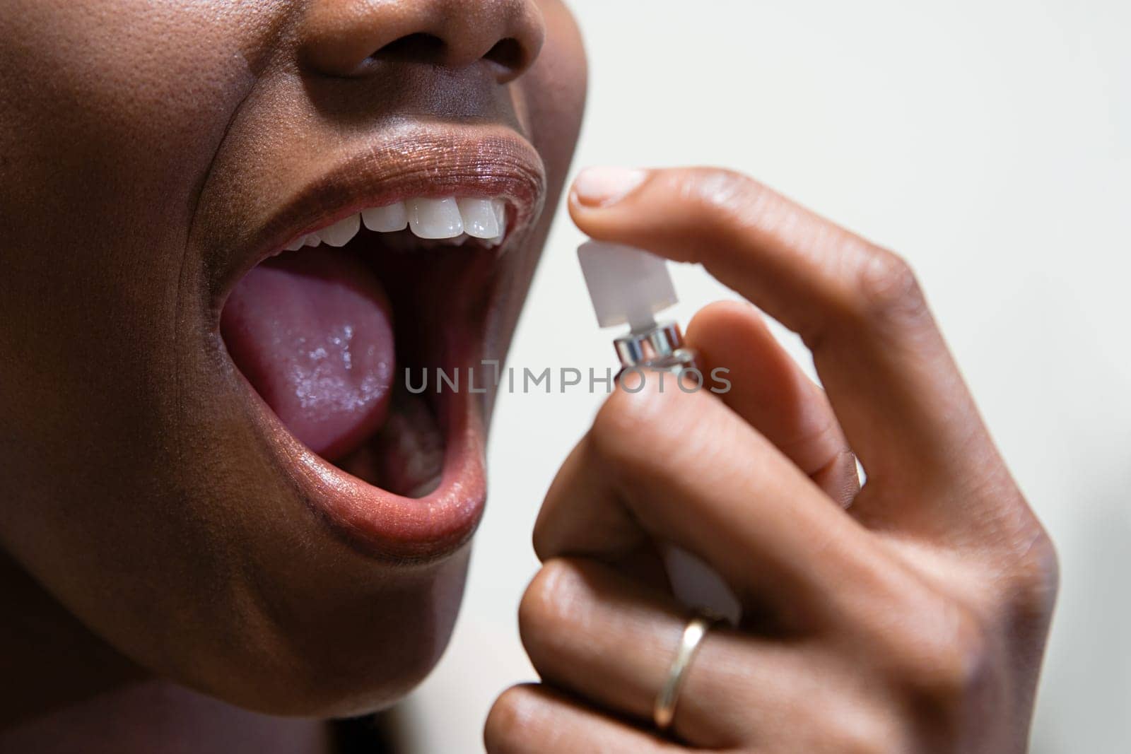 Woman using breath freshener