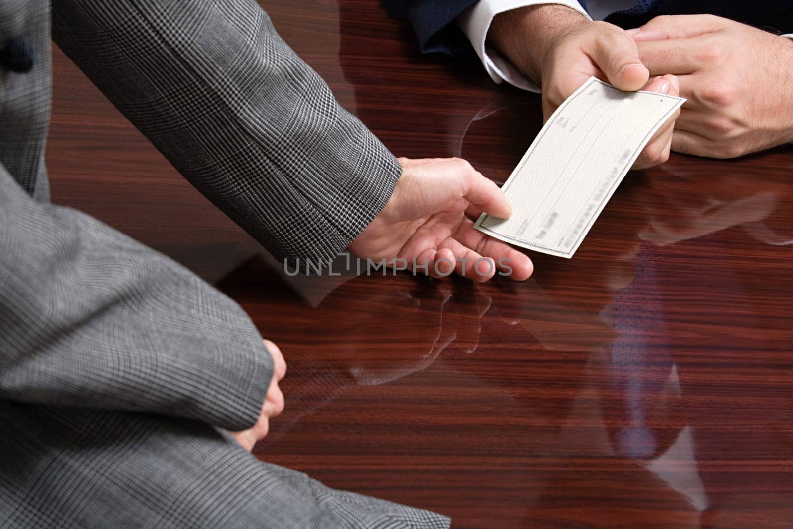 Businessman and businesswoman with blank cheque