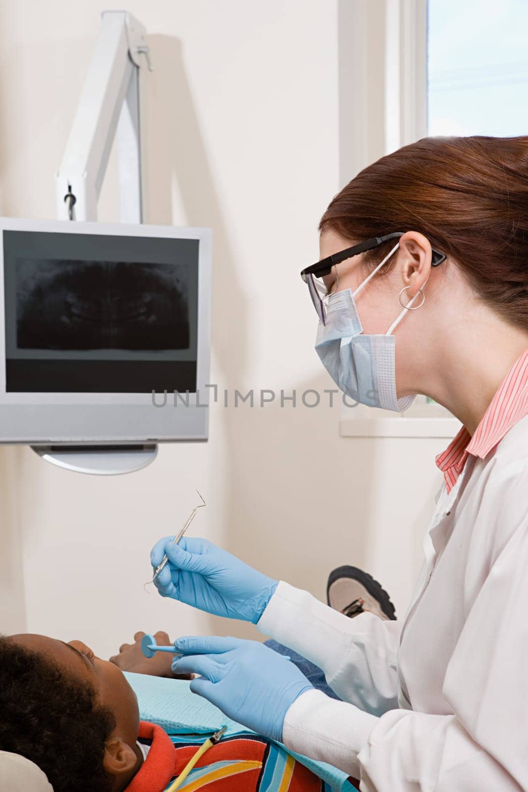 Boy having teeth examined