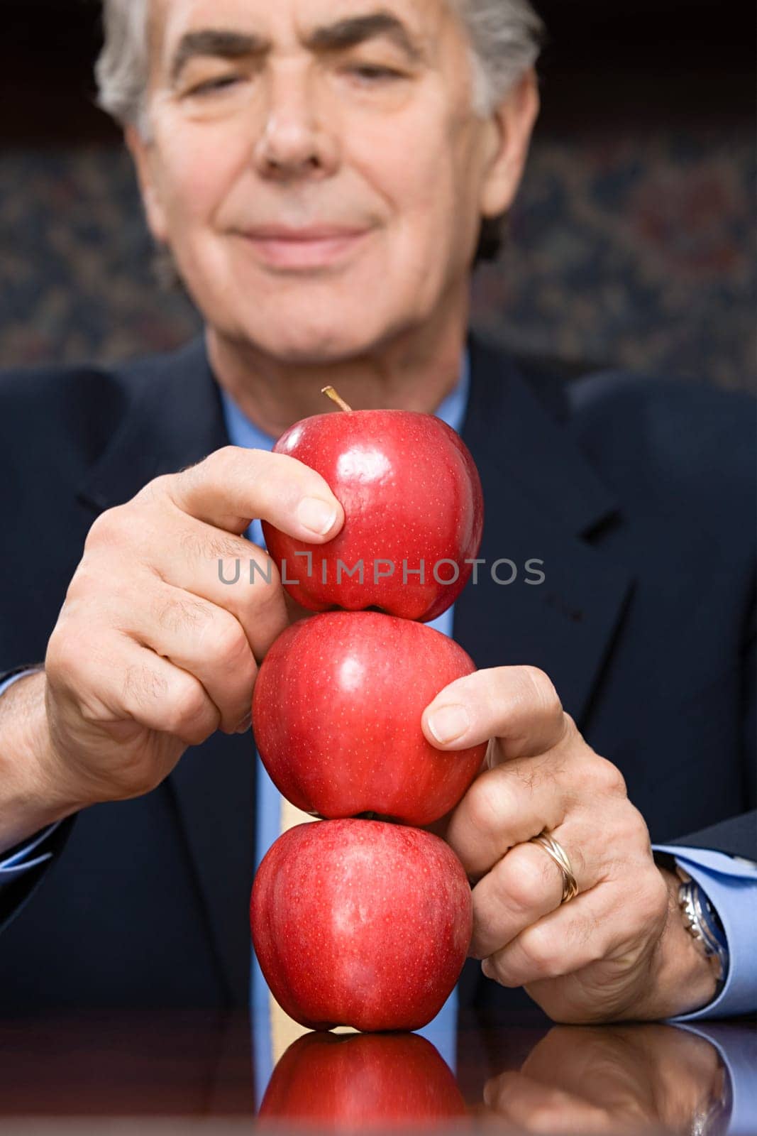 Businessman balancing apples