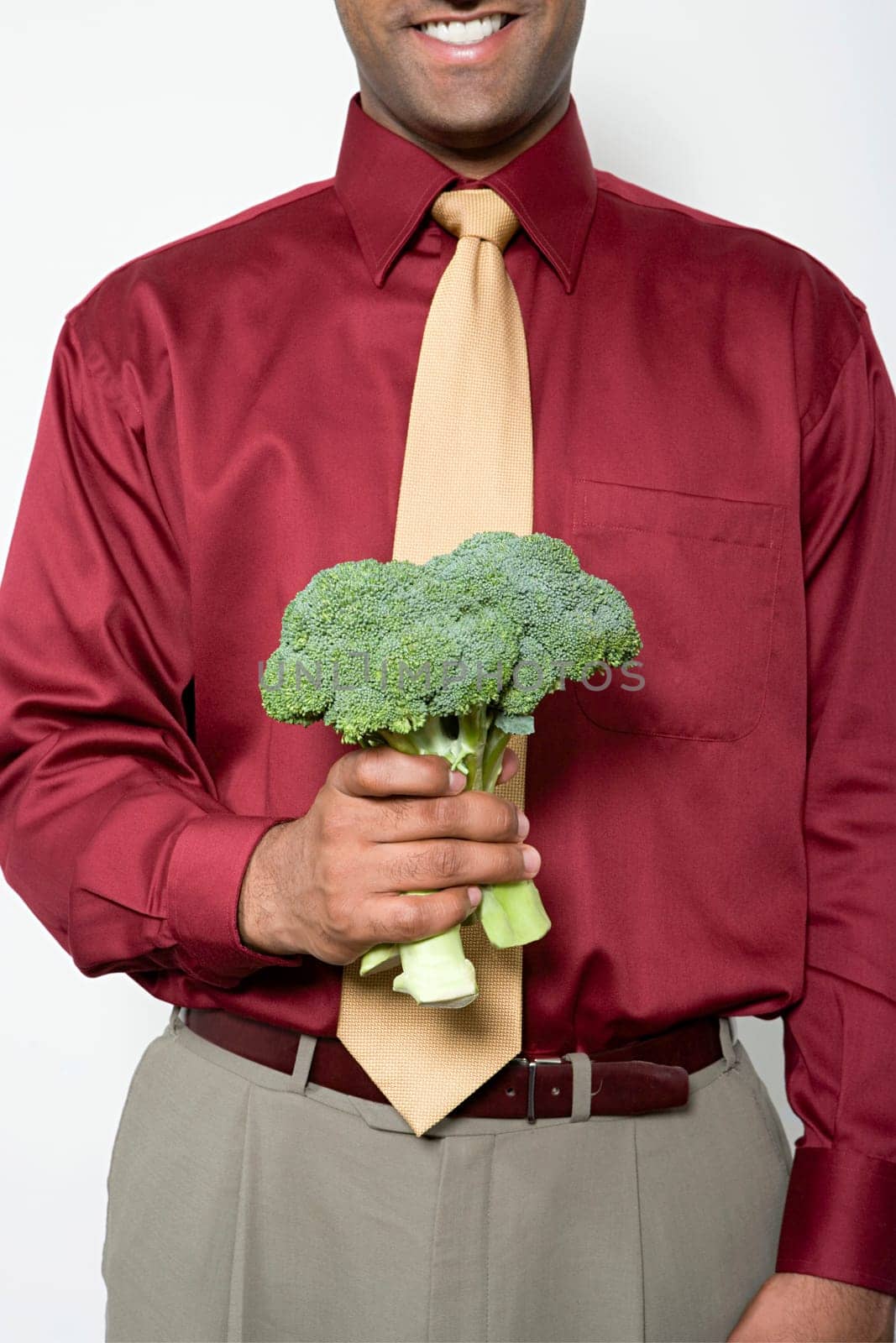 Man holding a bunch of broccoli