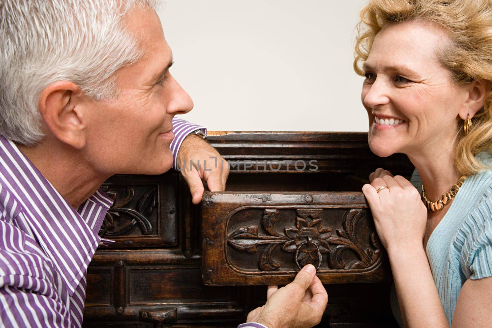 Couple looking at chest of drawers