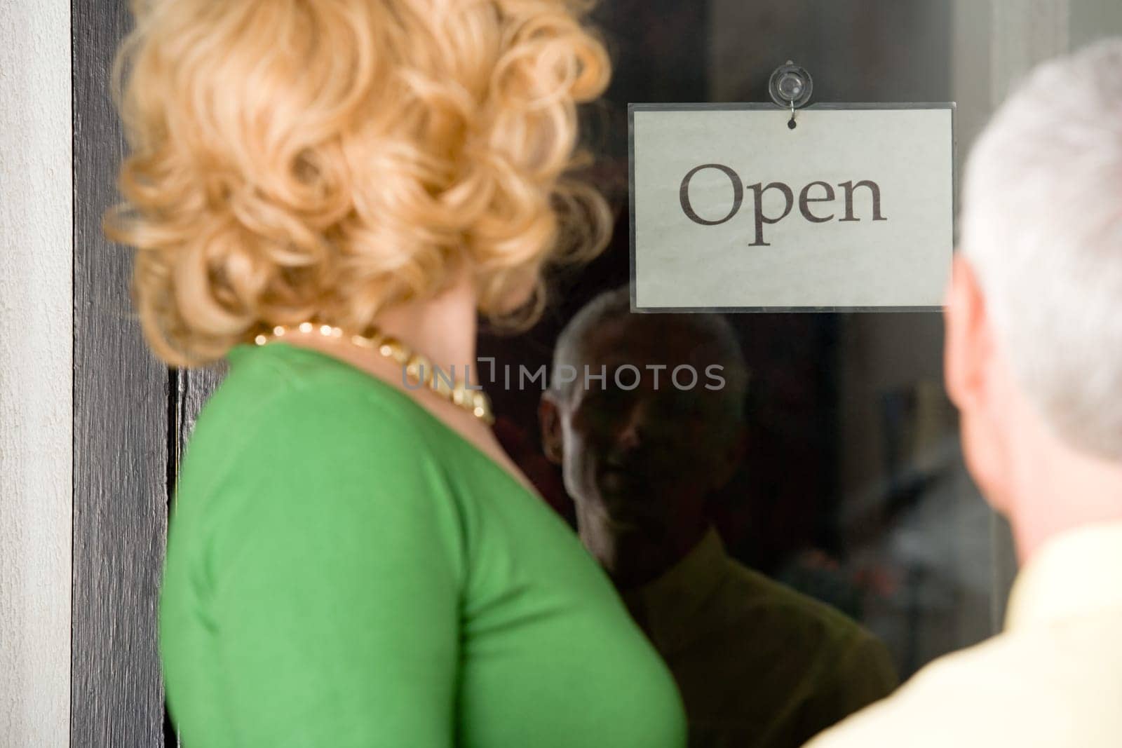 Couple looking at sign in shop window