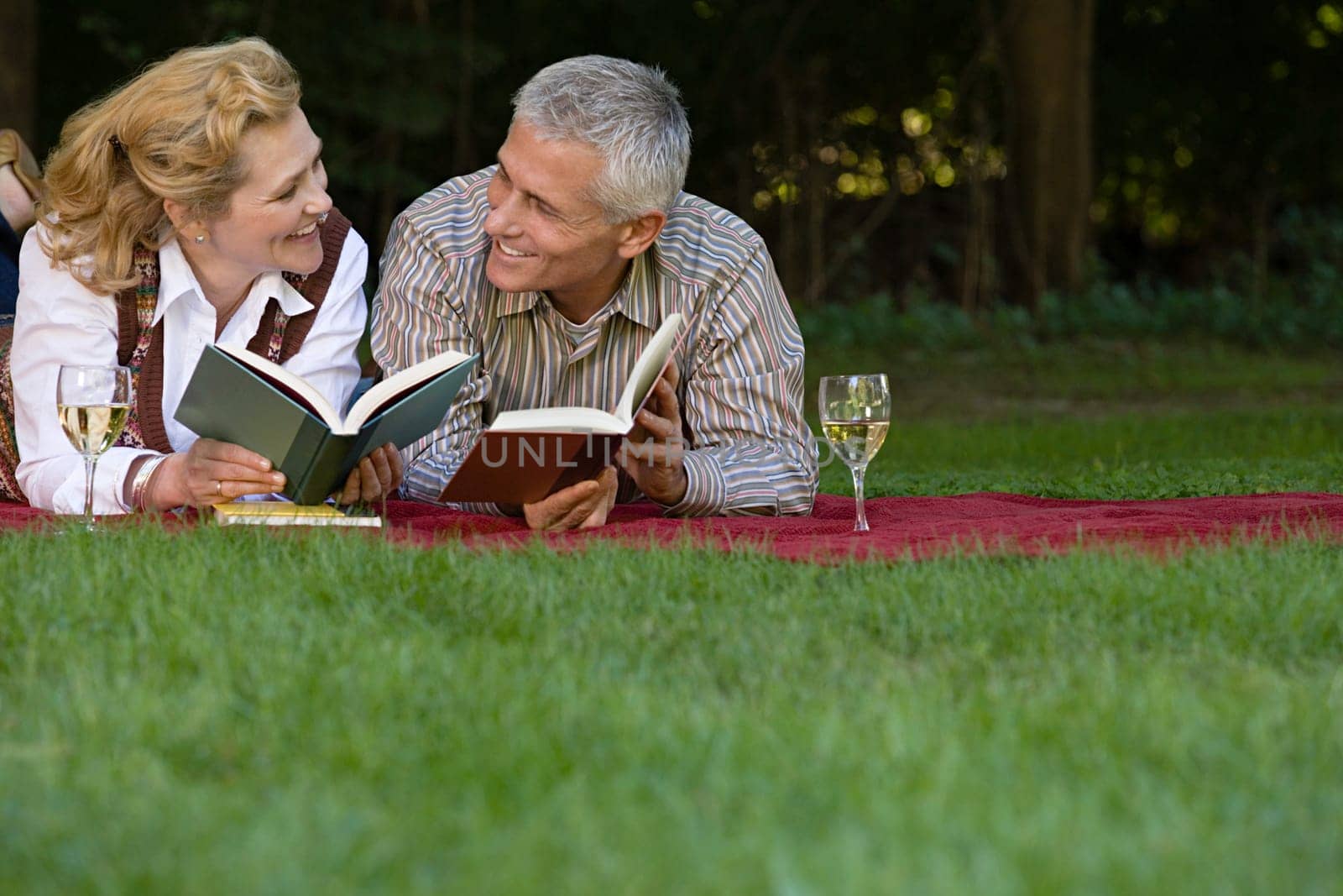 Couple relaxing with books and wine