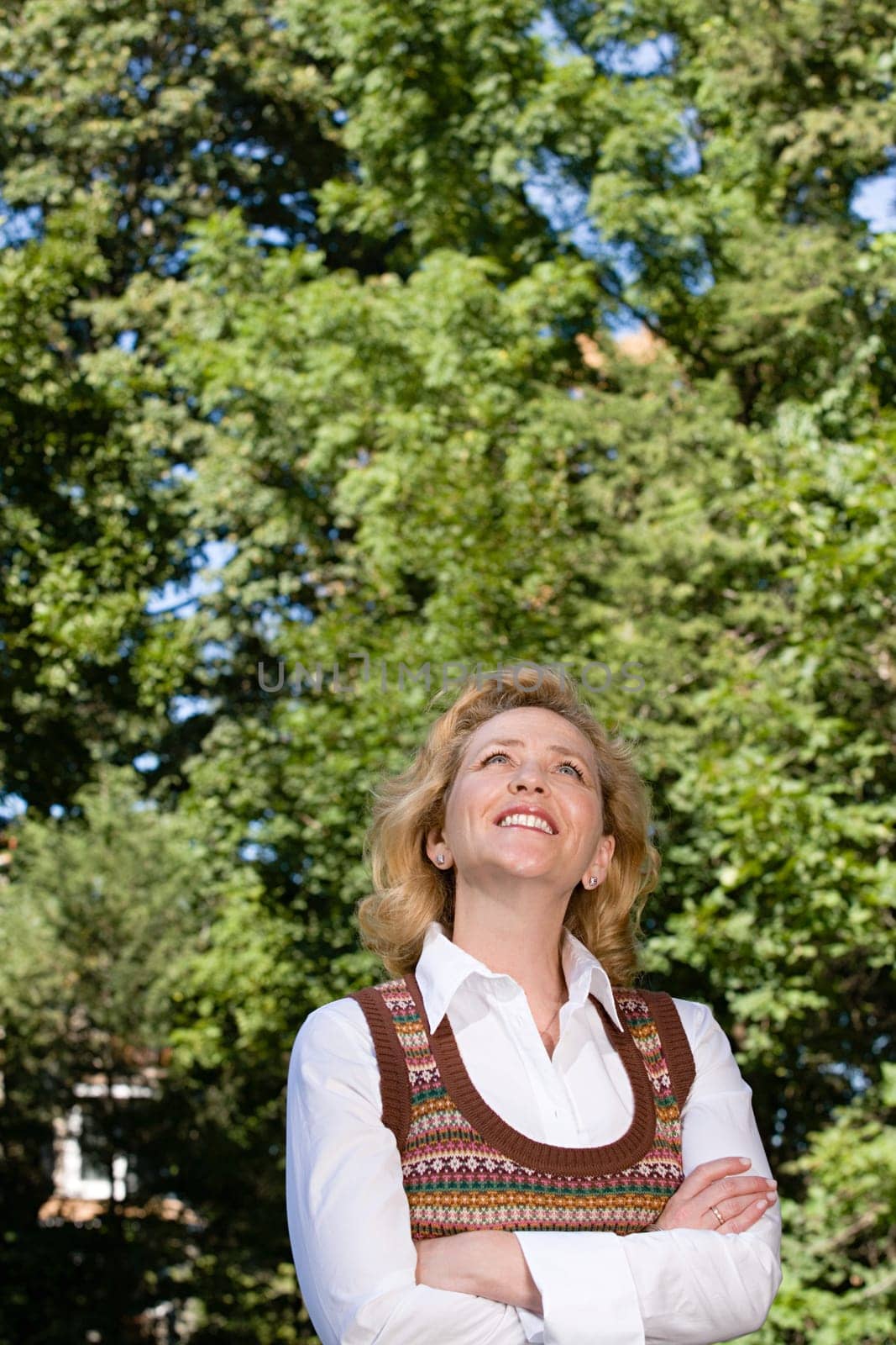 Woman outdoors looking up