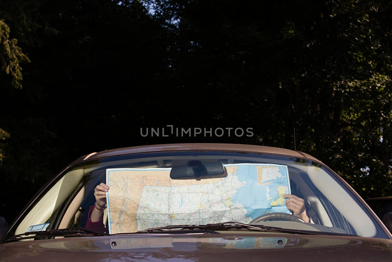 People in car with map