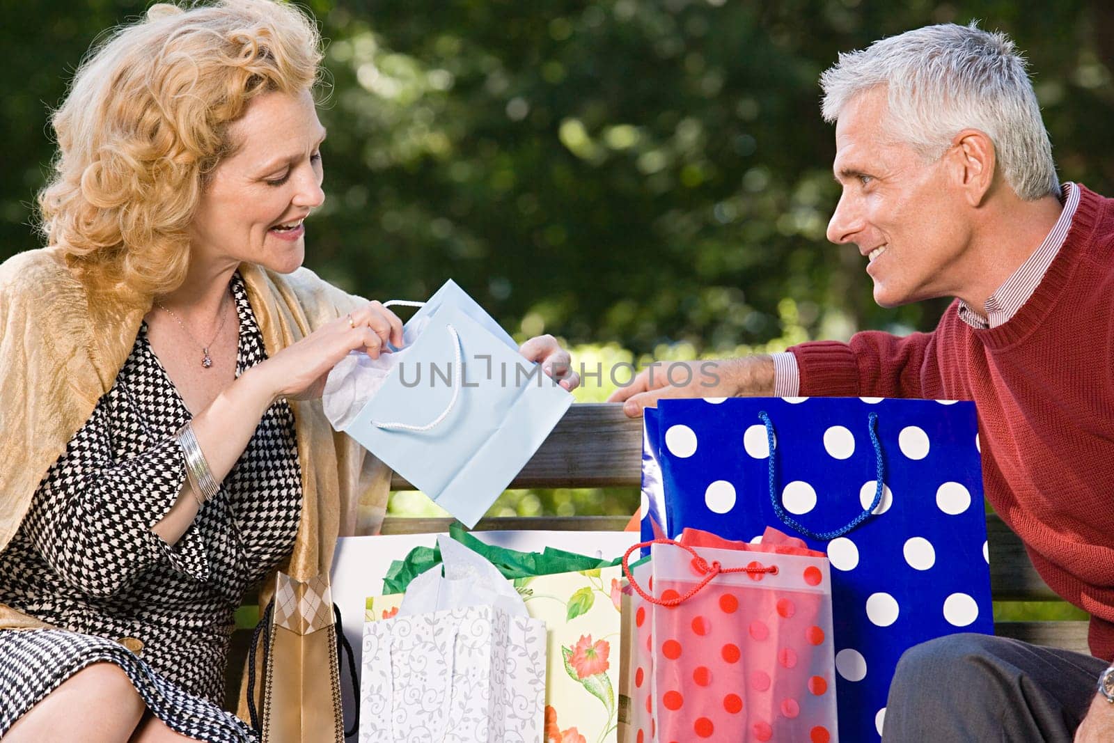 Woman looking in bag at gift from husband