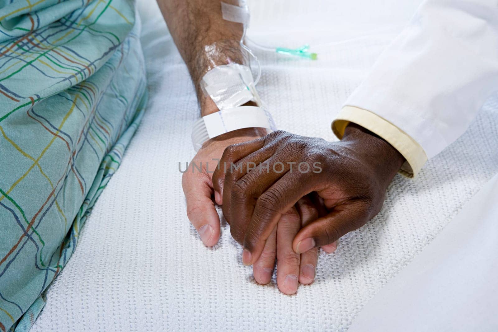 Doctor holding patients hand