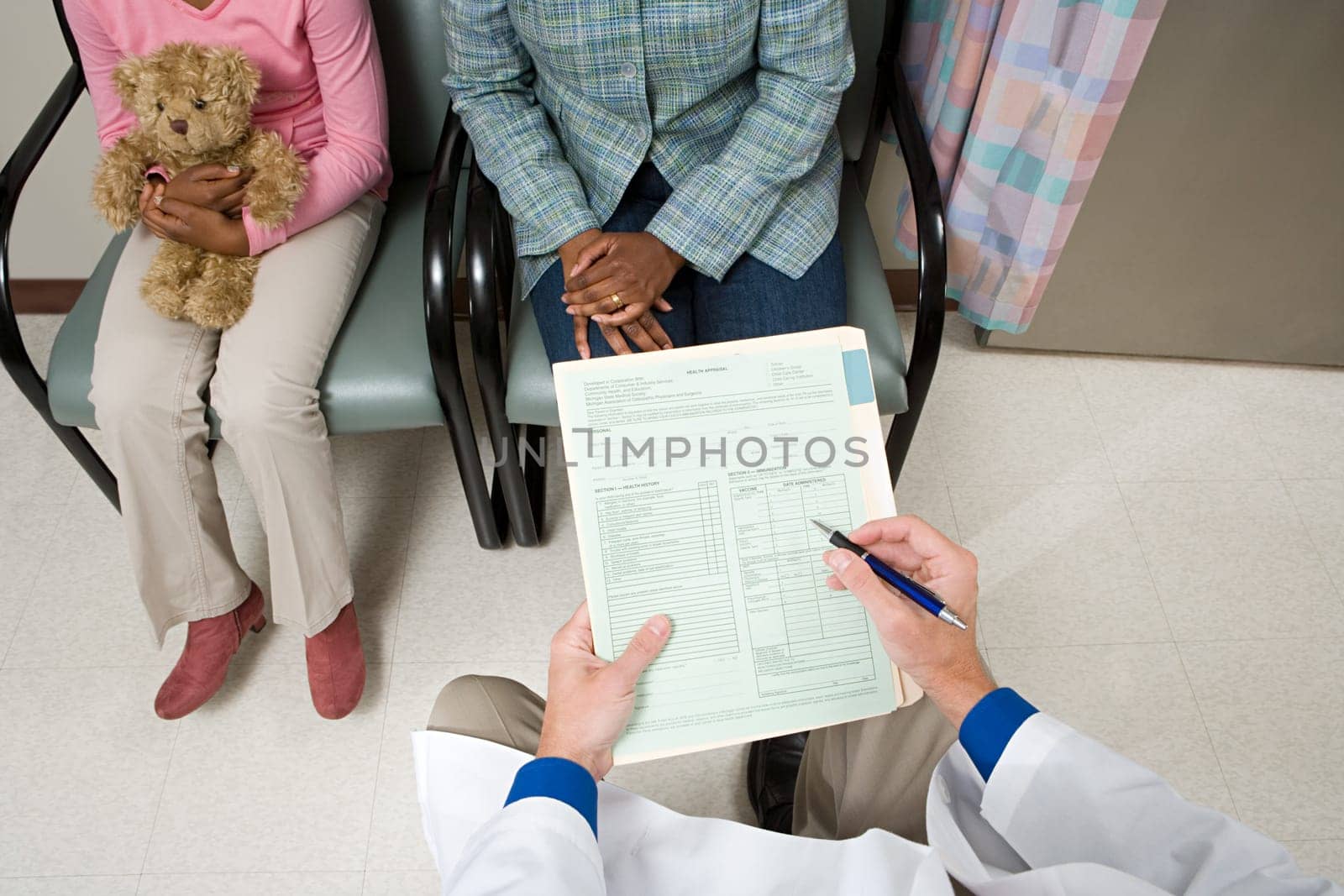 Doctor consulting parent and child