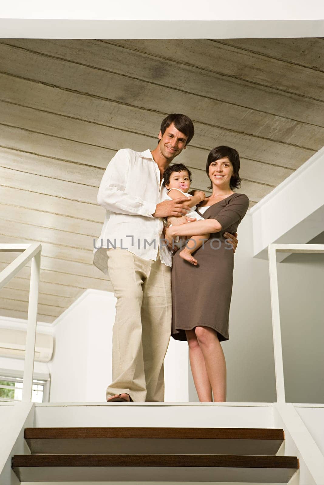 Family standing at the top of stairs