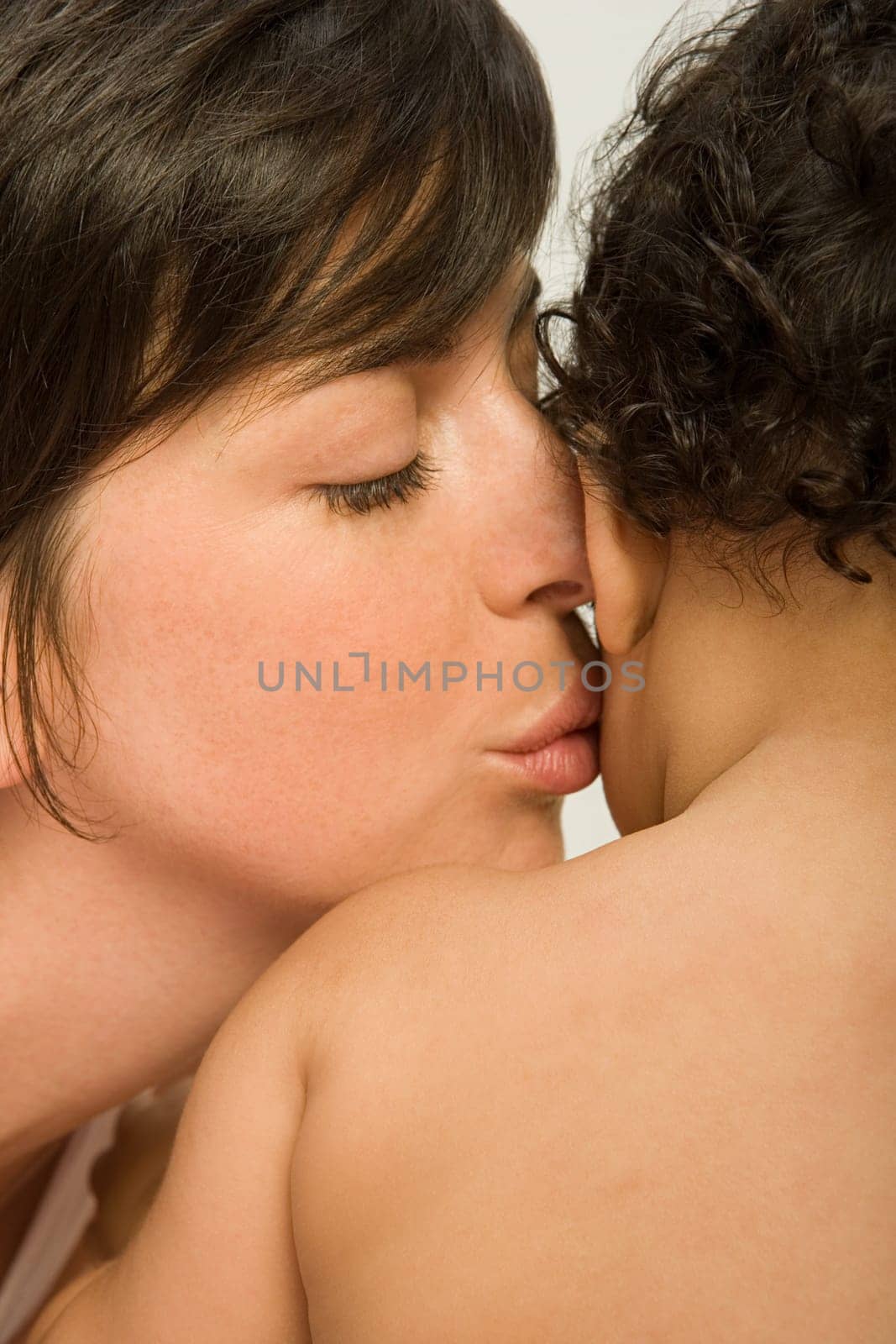 Mother kissing baby