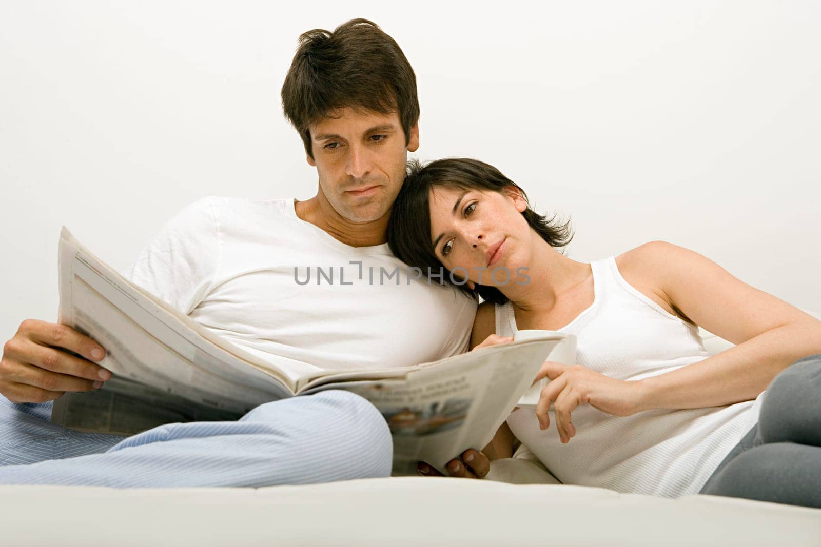 Couple reading newspaper