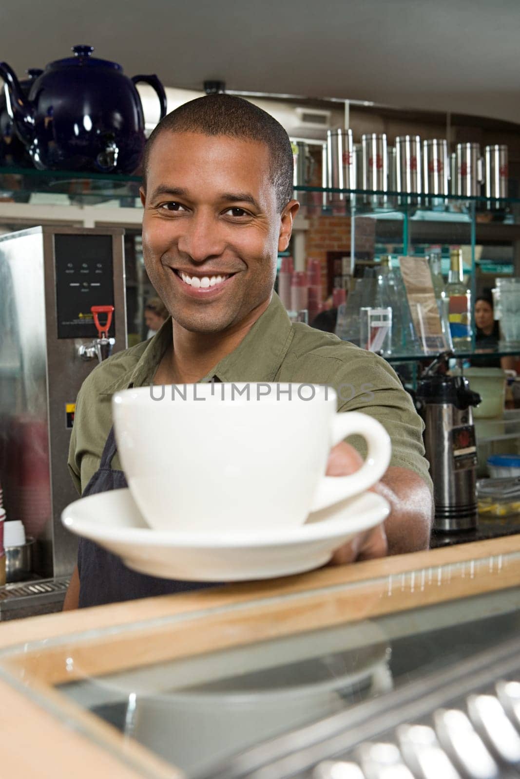 Waiter passing coffee cup