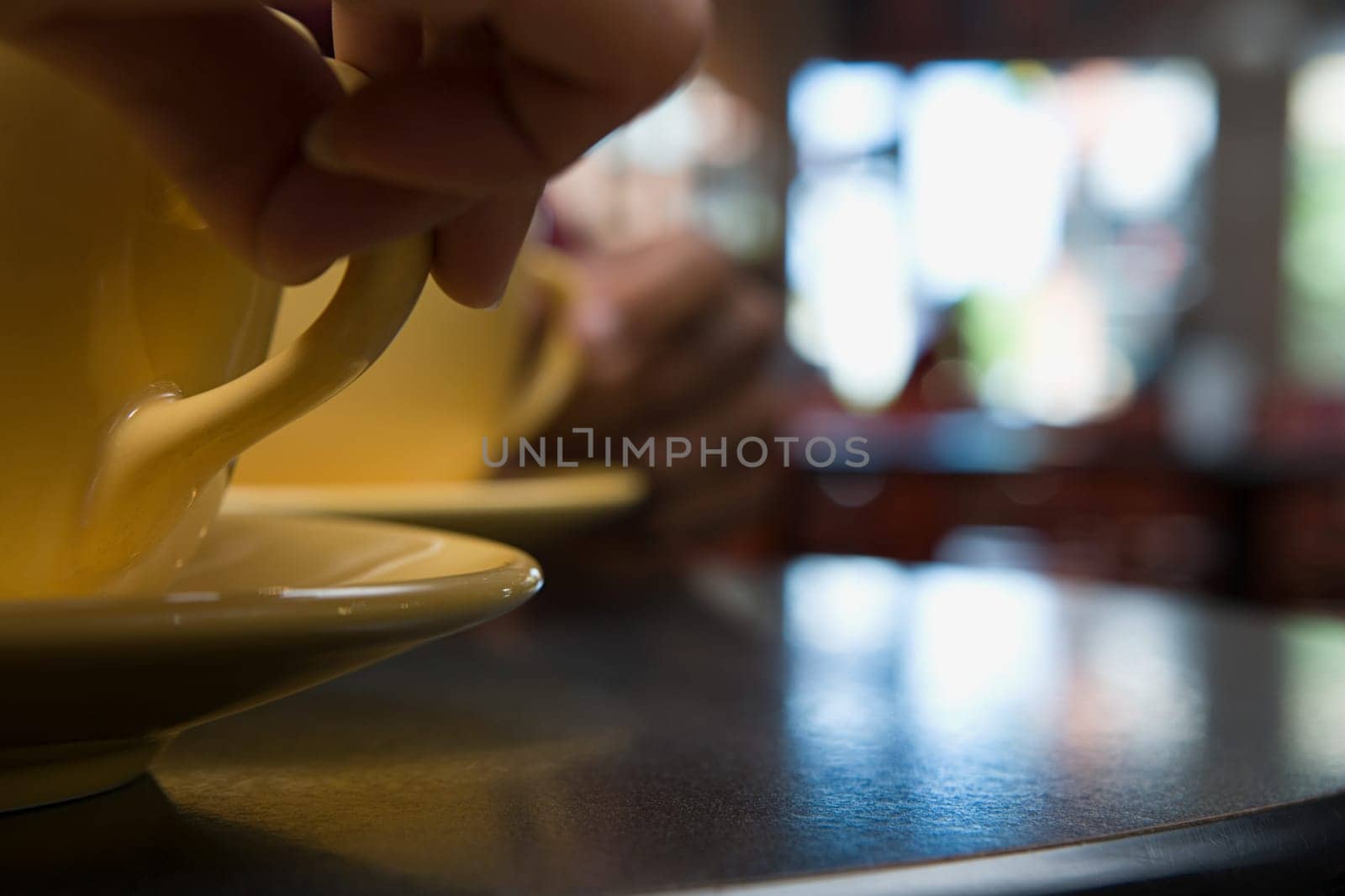Person holding coffee cup